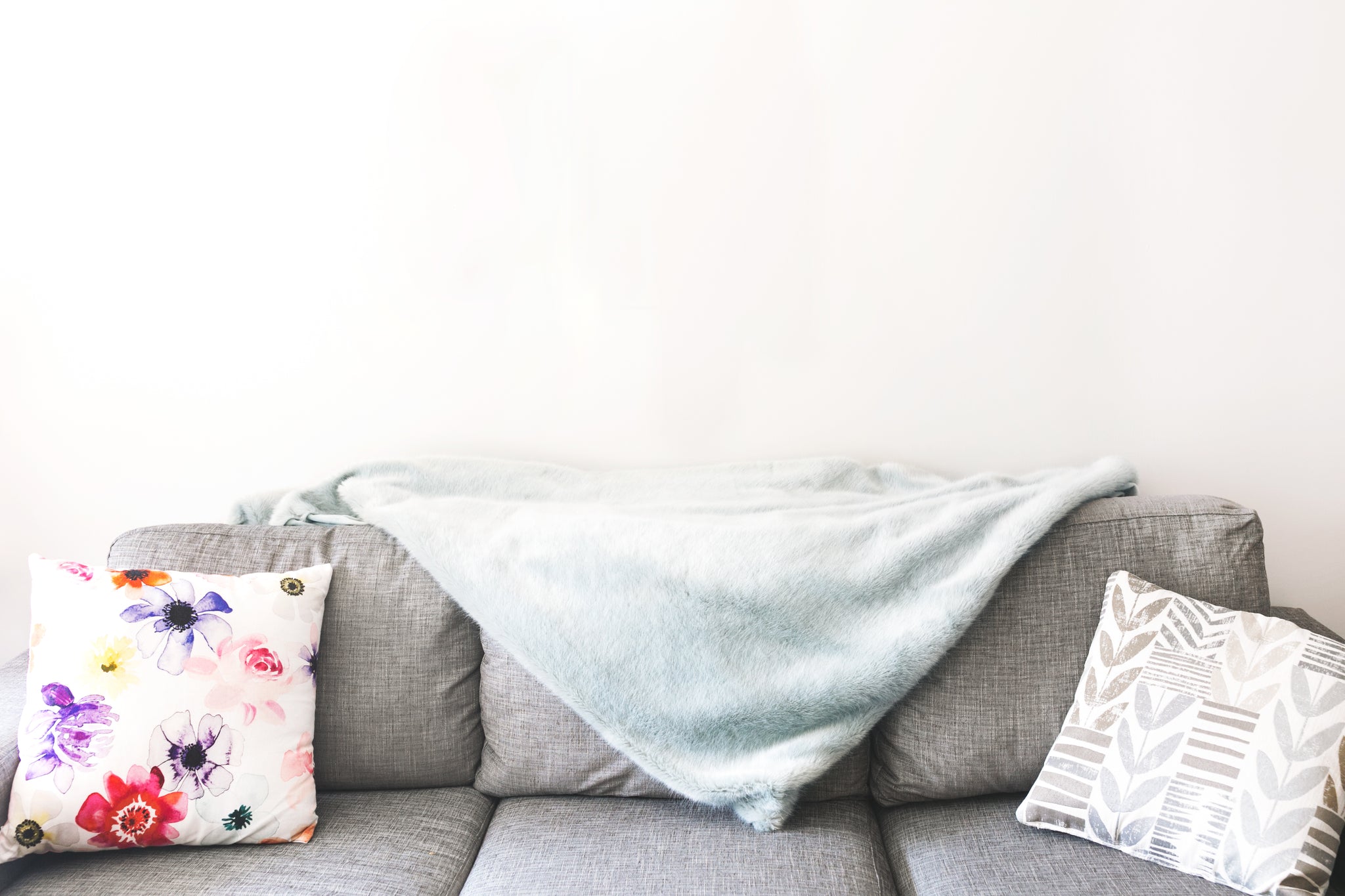 A Mill Street woven blanket styled on a sofa